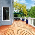 Spacious wooden deck with outdoor furniture and blue plant pots, reflecting XTEND Contracting’s craftsmanship in deck construction and window installation.